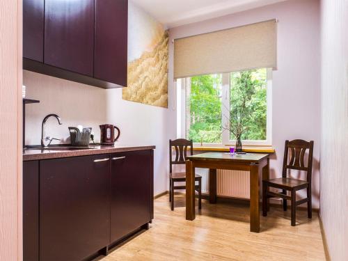 a kitchen and dining room with a table and a window at KEMERI Hotel in National Park - FREE PARKING in Jūrmala