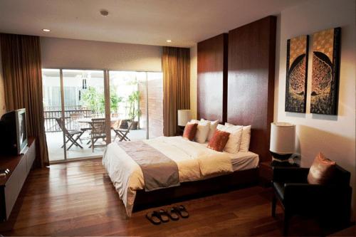 パタヤ・サウスにあるシャトー デール ブティック リゾート スパ ヴィラズのベッドルーム(大型ベッド1台、バルコニー付)