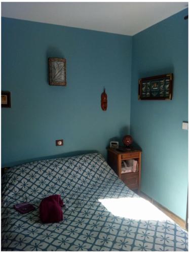 ein Schlafzimmer mit einem Bett und einer blauen Wand in der Unterkunft Entre mer et montagne in Montner