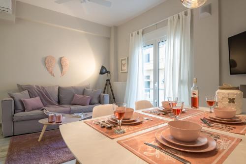 una sala de estar con una mesa y un sofá en "SunBow Earth"- Boutique new Apt in Dowtown Athens, en Atenas