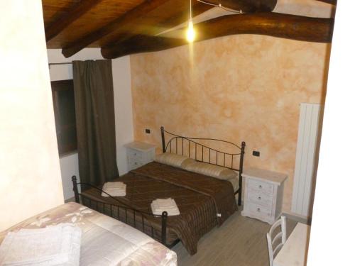 a bedroom with a bed in a room at Fattoria Sos Astores in Fonni