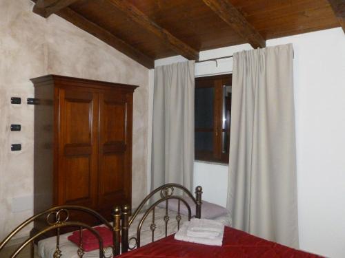 a bedroom with a table and chairs and a window at Fattoria Sos Astores in Fonni