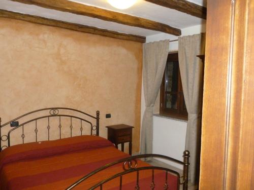 a bedroom with a bed and a window at Fattoria Sos Astores in Fonni