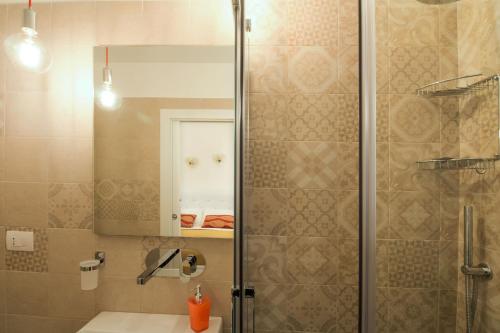 a bathroom with a shower with a sink and a mirror at Palazzo Rattazzi in Monopoli