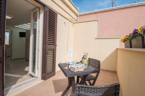 a small table and chairs on the balcony of a house at Palazzo Rattazzi in Monopoli
