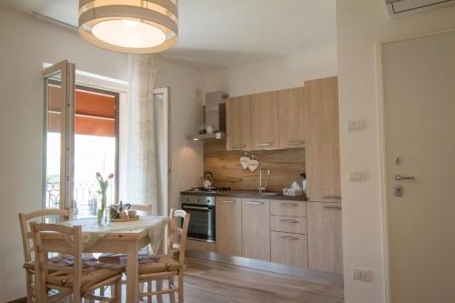 a kitchen with a table and chairs and a table and a dining room at Palazzo Rattazzi in Monopoli