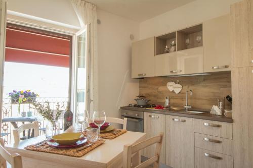 a kitchen with a table with wine glasses on it at Palazzo Rattazzi in Monopoli
