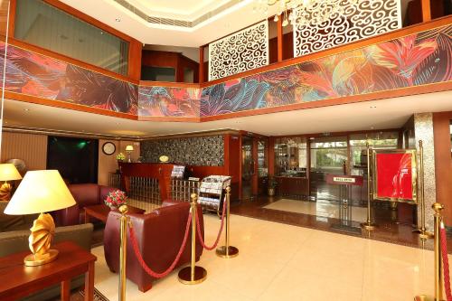 a living room with a couch and a table at Cochin Legacy in Cochin