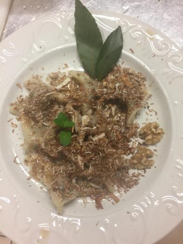 a plate of food with a green plant on it at Agriturismo Randis in Piano dʼArta