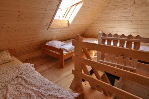 JunoszynoにあるLeniuchowoのログキャビン内のベッド2台が備わる部屋です。