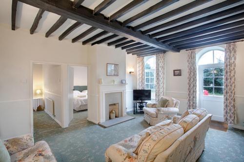 a living room with a couch and a fireplace at The Grove Cromer in Cromer