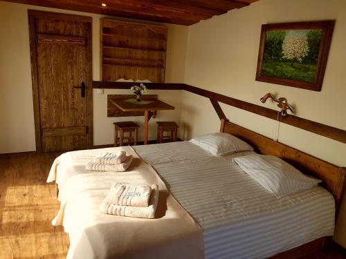 a bedroom with a bed with towels on it at Guest House and camping Jurmala in Jūrmala