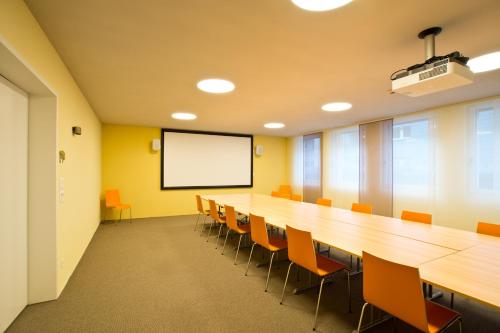 a large conference room with a long table and chairs at Ochsen Lenzburg in Lenzburg