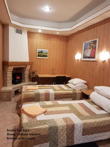 a hotel room with two beds and a fireplace at Sky High Hotel Airport 200 meters from the terminal in Rīga