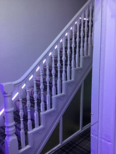 a purple stair railing with lights on it at The Danescourt in Blackpool