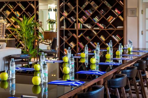 a row of tables in a room with wine bottles at Hotel Brown Beach House & Spa in Trogir