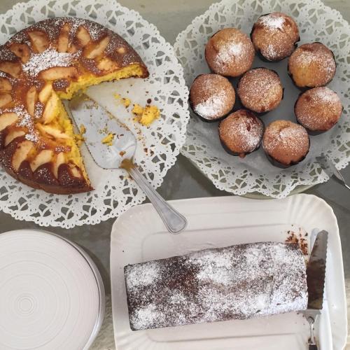 a table with two plates of food with a cake and muffins at Masserie Maresca in Ostuni