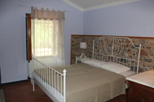 a bedroom with a white bed and a window at Fontanacota in Imperia