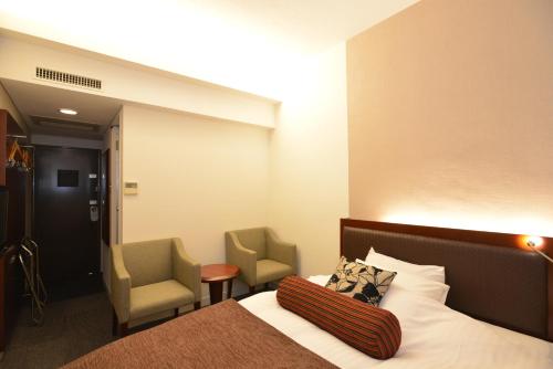 Säng eller sängar i ett rum på Yamato Kashihara City Hotel