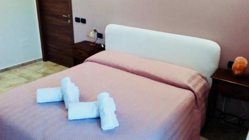 a bedroom with a bed with blue stuffed animals on it at B&B San Paolo in Campagna