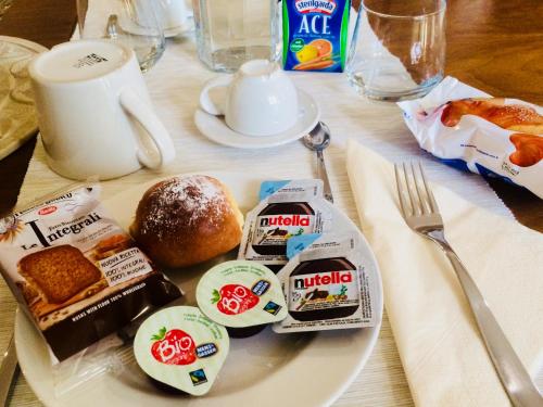 a white plate with breakfast food on a table at B&B San Paolo in Campagna