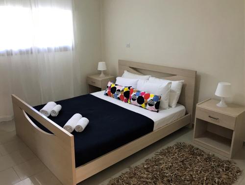 a bedroom with a large bed with two pillows at Kyklades Resort & Spa in Paralimni