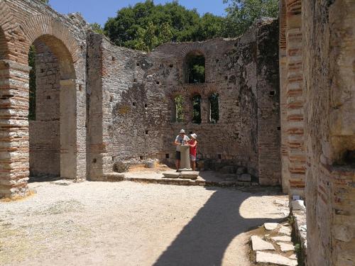 two people standing in an old stone building at Vacanze Pushime Albania in Radhimë