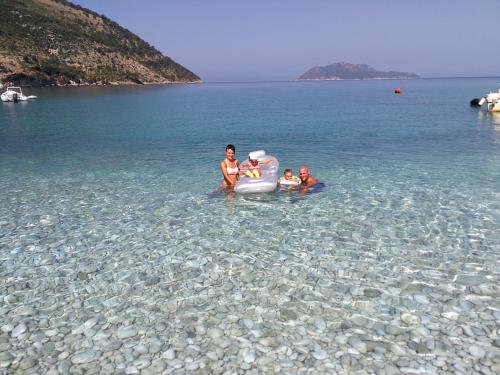 a group of people in the water on a lake at Vacanze Pushime Albania in Radhimë
