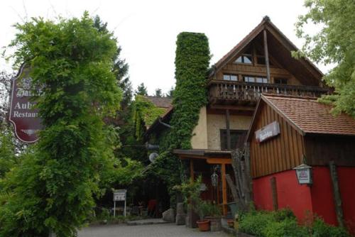 a large building with a balcony on top of it at Alte Schreinerei-Auberge Harlekin in Singen