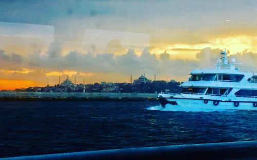 a large white boat in the water at sunset at ARINÇ HOTEL in Istanbul