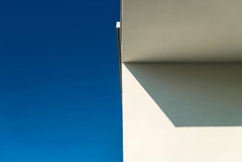 a corner of a room with a blue and white wall at Hotel Villa Katy in Bardolino
