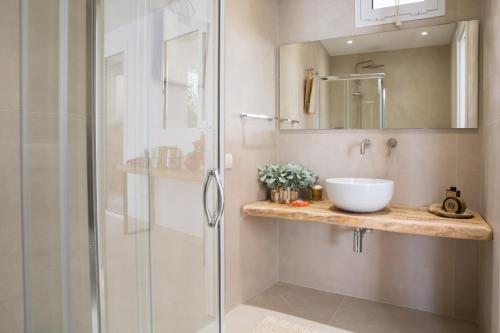 a bathroom with a glass shower and a sink at Residence Porto Grande in Leuca