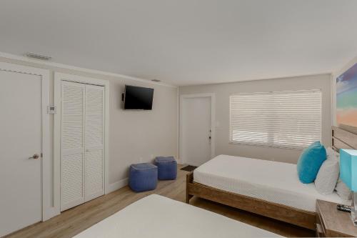 a bedroom with a bed and a television at Drift Hotel in Key Largo