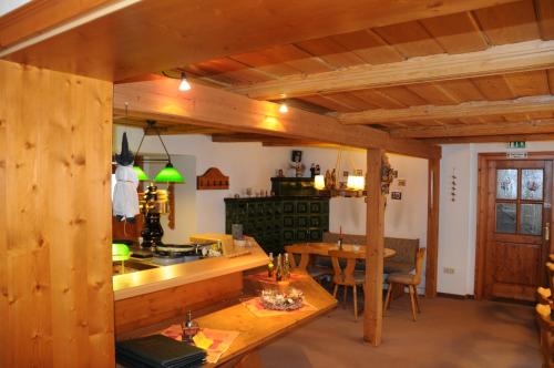 a kitchen and dining room with wooden ceilings and a table at Pension Klette in Kurort Oybin