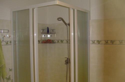 a bathroom with a shower with a glass door at Guest House Vītoli in Kolka