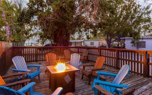 a table and chairs with a candle on a deck at Drift Hotel in Key Largo