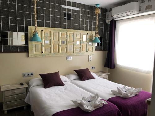 Ein Bett oder Betten in einem Zimmer der Unterkunft Hostal Boutique Luna de Gavín