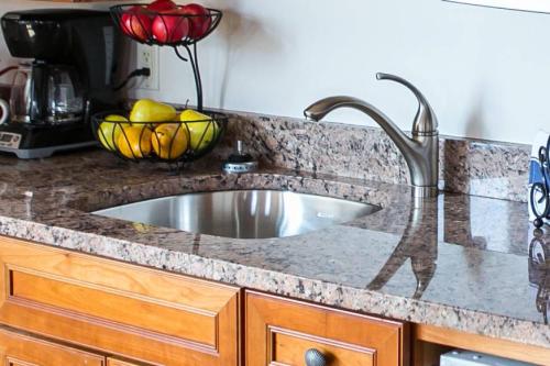 a kitchen counter with a sink and a bowl of fruit at Newport Bay Club and Hotel in Newport