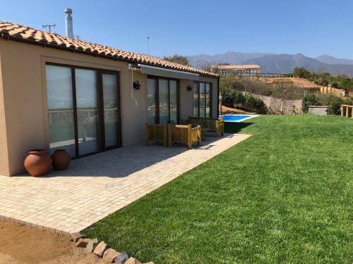 a house with a patio and a grass yard at Villas Toscanas in Limache