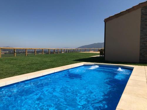 a large blue swimming pool next to a building at Villas Toscanas in Limache