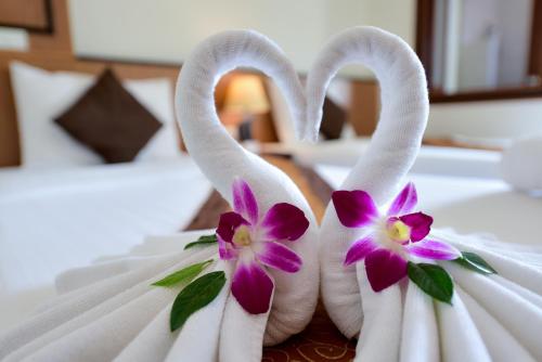 two swans dressed up in a wedding dress with flowers at Rapeepan Ville Hotel in Ubon Ratchathani