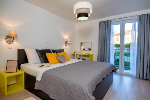 a bedroom with a bed and a large window at Villa Kala Komiža in Komiža