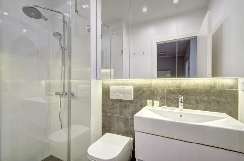 a bathroom with a toilet and a sink and a shower at Apartament 6 Old Town in Gdańsk