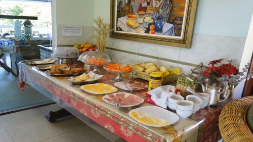 a buffet table with food on top of it at Solar do Forte Flats in Ubatuba