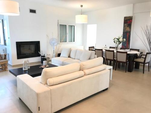 a living room with a white couch and a table at Villa Korais Luxury 3br apt with sea view in Thessaloniki