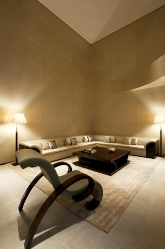 a living room with a couch and a table at Armani Hotel Milano in Milan