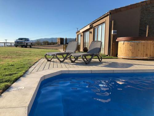 a couple of chairs sitting next to a swimming pool at Villas Toscanas in Limache
