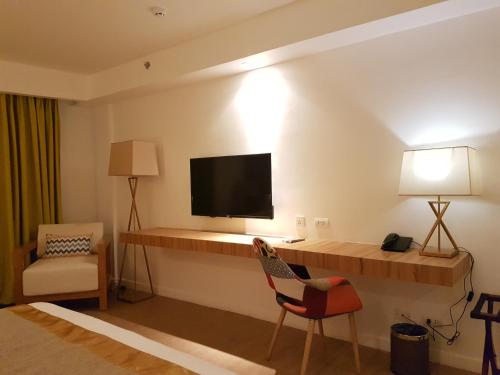 Ferra Hotel and Garden Suitesにあるテレビまたはエンターテインメントセンター