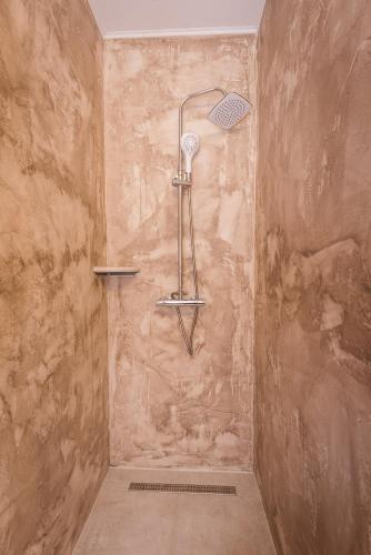 a shower with a shower head in a bathroom at Boutique Hostel Livia in Metković