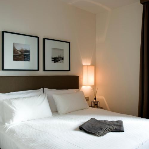 a bedroom with a white bed with a towel on it at Marina Place Resort in Genova